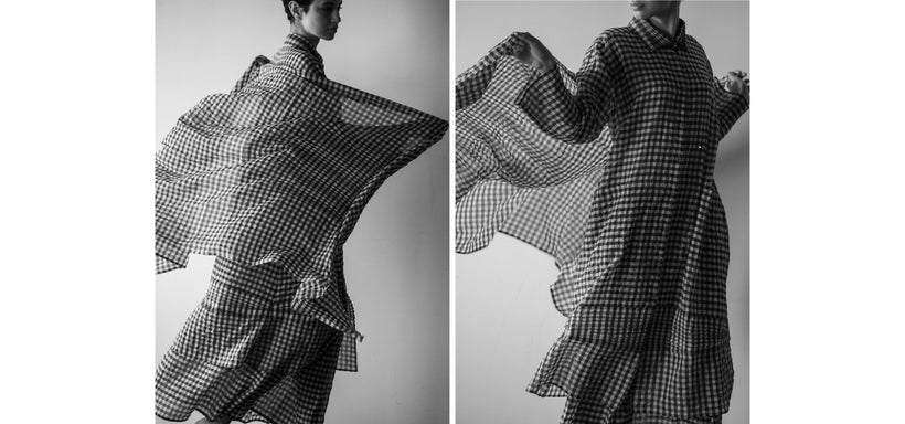 Left: Model wearing 2 SIDE PINTUCKING Shirt, Skirt and Stole in Black, against a light grey background. Right: Model wearing 2 SIDE PINTUCKING Shirt, Skirt and Stole in Black, against a light grey background.