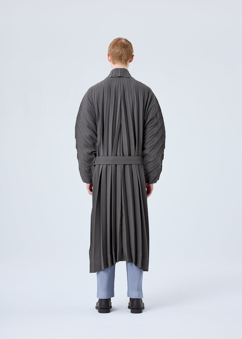 A model wears the HOMME PLISSÉ ISSEY MIYAKE  EDGE COAT coat