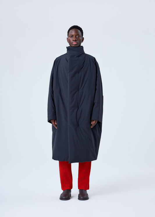 A model wears the HOMME PLISSÉ ISSEY MIYAKE BLANK DUVET COAT coat.