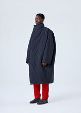 A model wears the HOMME PLISSÉ ISSEY MIYAKE BLANK DUVET COAT coat.