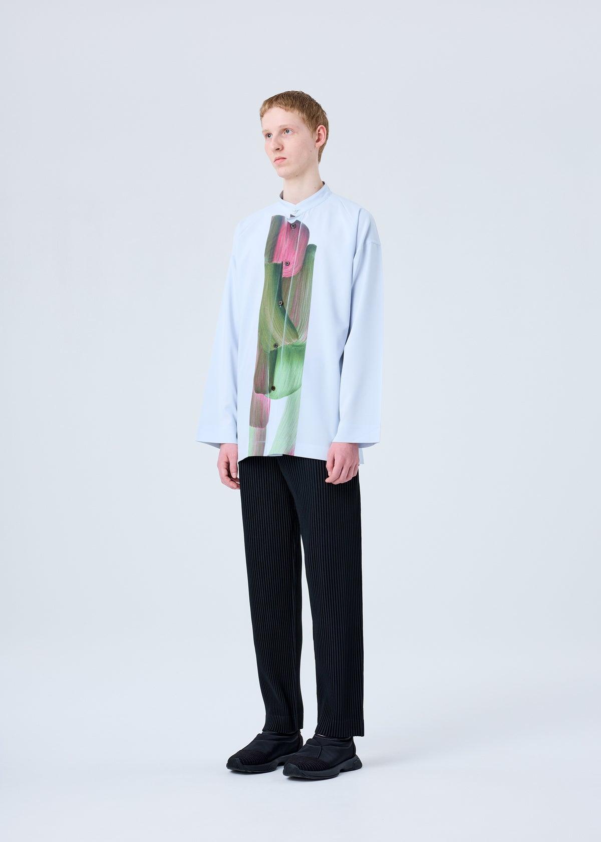 A model wears the HOMME PLISSÉ ISSEY MIYAKE RB_DRAWING PRESS SHIRT 1 shirt