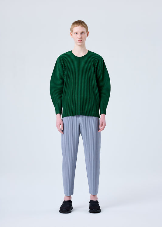 A model wears the HOMME PLISSÉ ISSEY MIYAKE MC AUGUST trousers