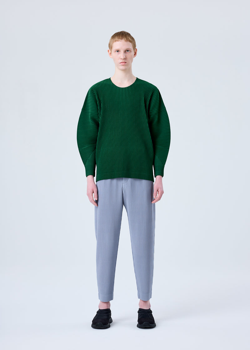 A model wears the HOMME PLISSÉ ISSEY MIYAKE MC AUGUST trousers