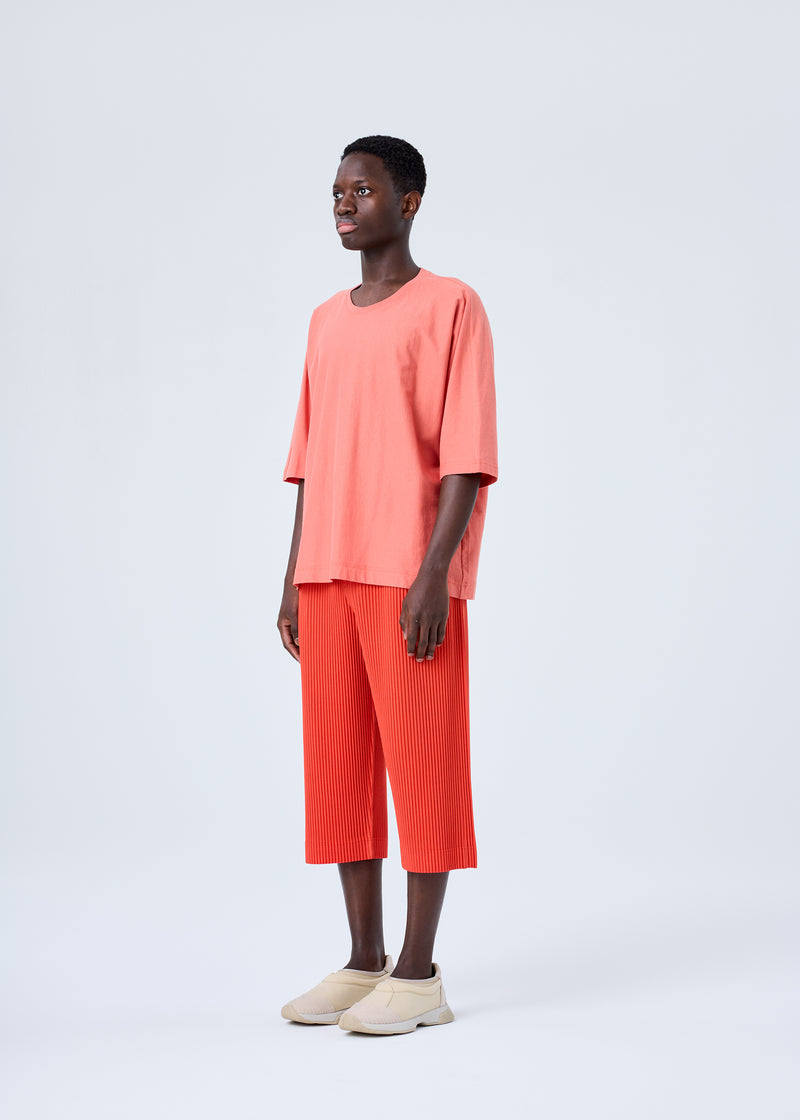 A model wears the HOMME PLISSÉ ISSEY MIYAKE  PLEATS BOTTOMS 1 trousers