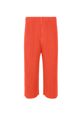 A product shot of the HOMME PLISSÉ ISSEY MIYAKE  PLEATS BOTTOMS 1 trousers in salmon red (27)