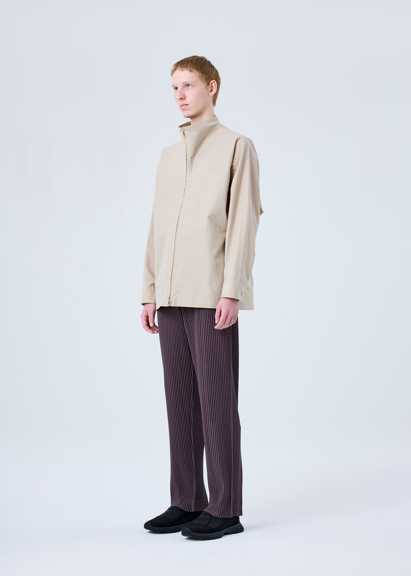 A model wears the HOMME PLISSÉ ISSEY MIYAKE  PLEATS BOTTOMS 1 trousers