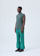 A model wears the HOMME PLISSÉ ISSEY MIYAKE PLEATS BOTTOMS 2 trousers.