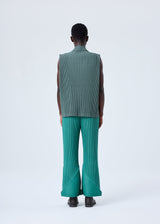 A model wears the HOMME PLISSÉ ISSEY MIYAKE PLEATS BOTTOMS 2 trousers.