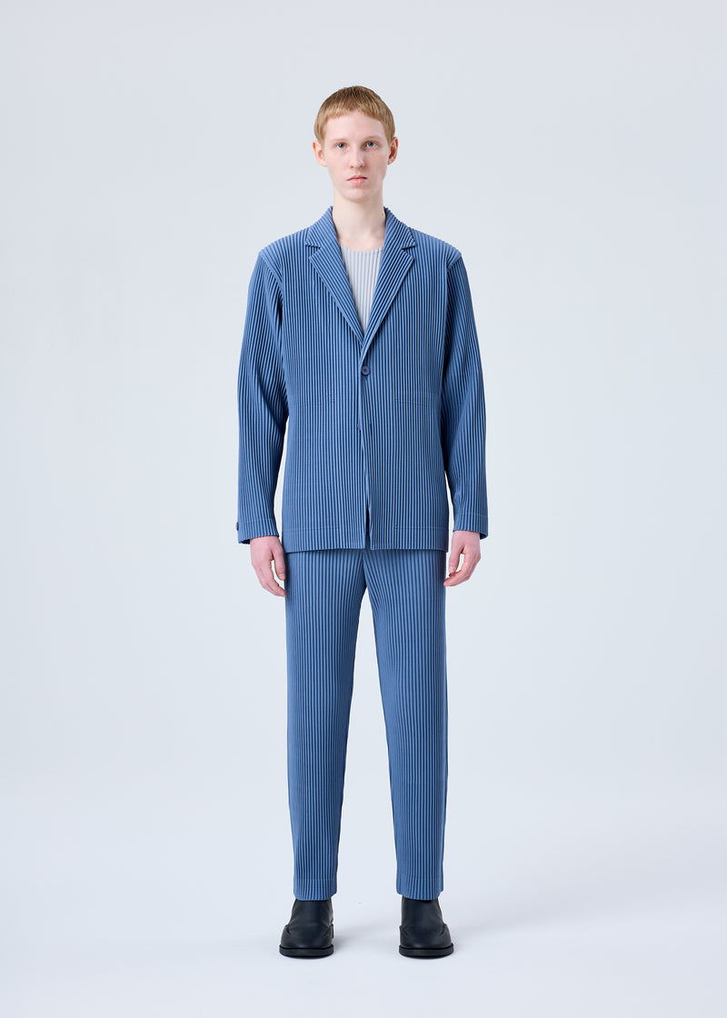 A model wears the HOMME PLISSÉ ISSEY MIYAKE TAILORED PLEATS 1 trousers