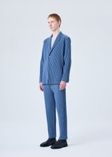 A model wears the HOMME PLISSÉ ISSEY MIYAKE TAILORED PLEATS 1 trousers