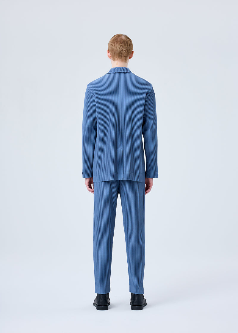 A model wears the HOMME PLISSÉ ISSEY MIYAKE TAILORED PLEATS 1 trousers