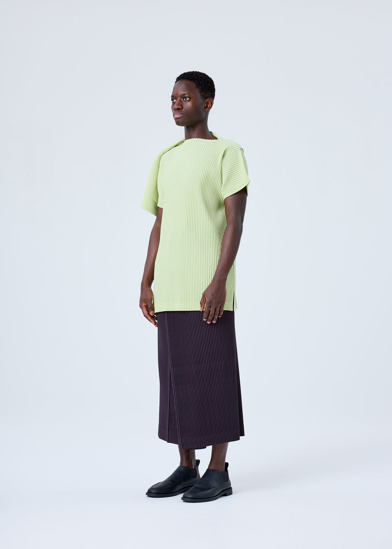 A model wears the HOMME PLISSÉ ISSEY MIYAKE RB_COLOR PALETTE 1 trousers