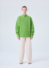 A model wears the HOMME PLISSÉ ISSEY MIYAKE RUSTIC KNIT top.