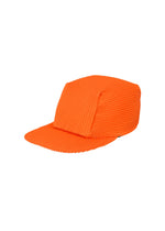 A product shot of the HOMME PLISSÉ ISSEY MIYAKE PLEATS CAP hat in orange (32).