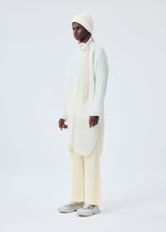 A model wears the HOMME PLISSÉ ISSEY MIYAKE BEANIE SCARF hat.