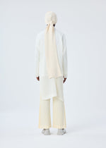 A model wears the HOMME PLISSÉ ISSEY MIYAKE BEANIE SCARF hat.