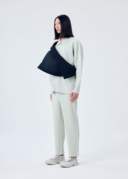 A model wears the HOMME PLISSÉ ISSEY MIYAKE OVERLAP bag.