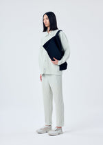 A model wears the HOMME PLISSÉ ISSEY MIYAKE OVERLAP bag.