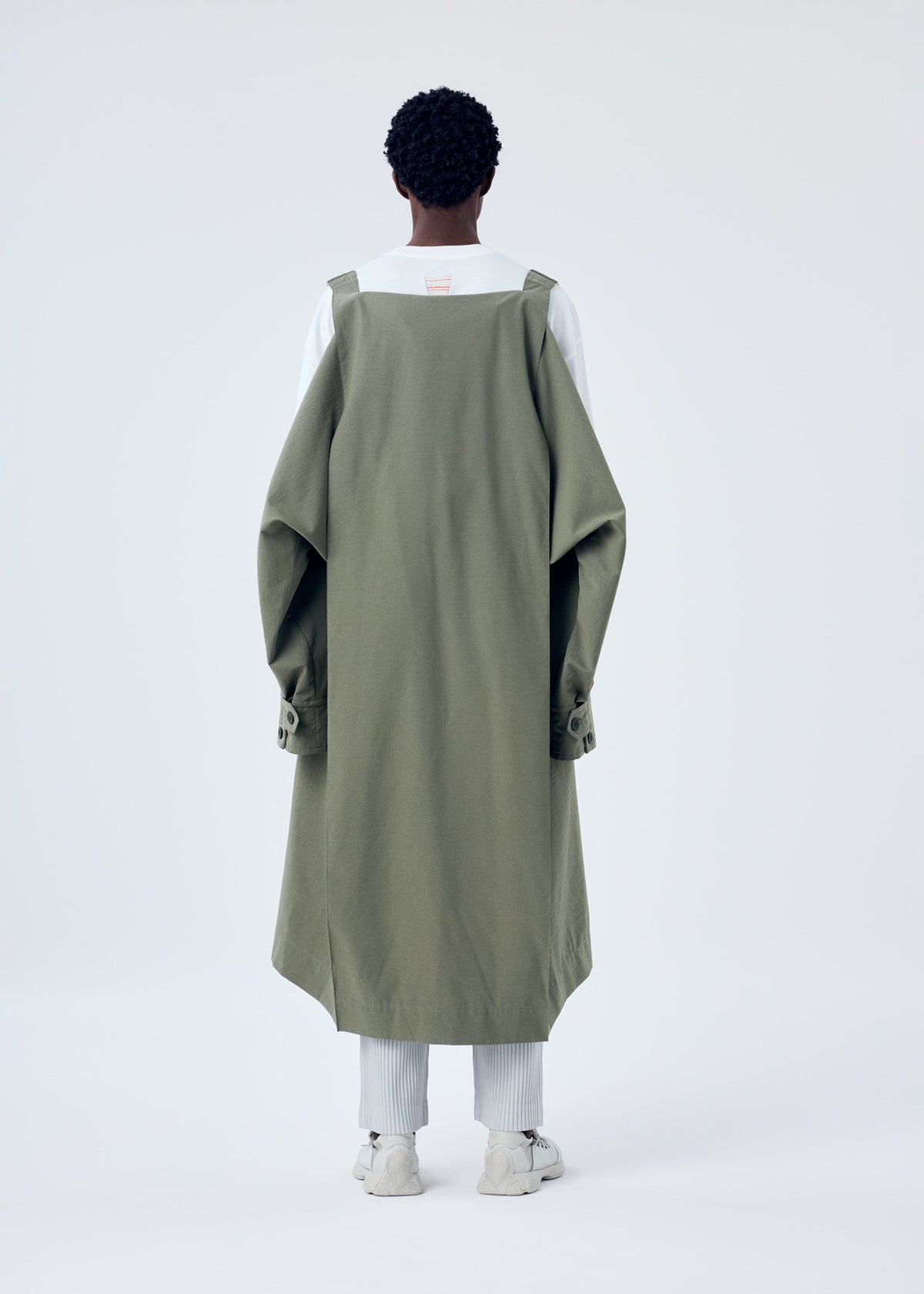 A model wears the HOMME PLISSÉ ISSEY MIYAKE PARACHUTE coat.