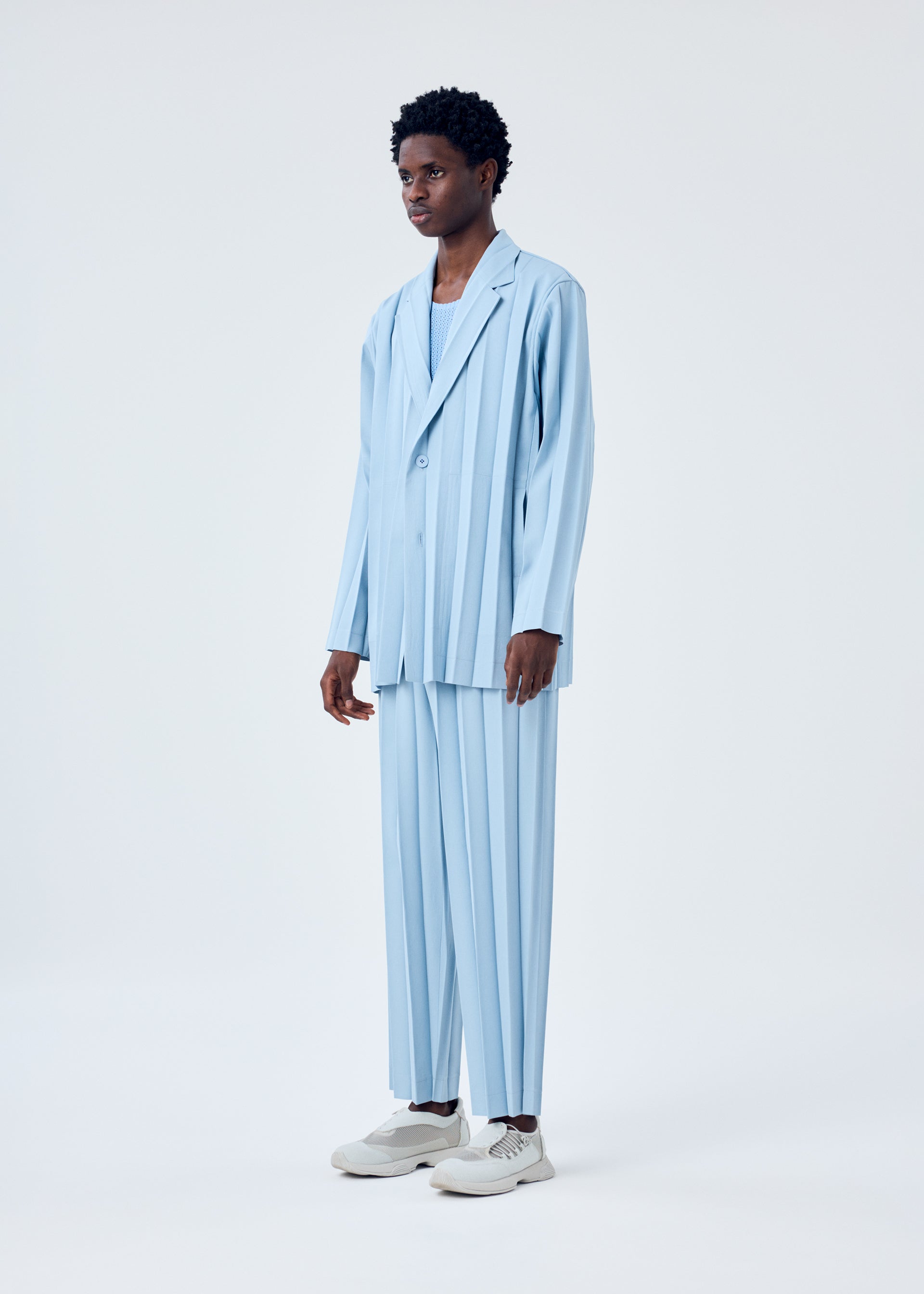 A model wears the HOMME PLISSÉ ISSEY MIYAKE EDGE ENSEMBLE jacket.