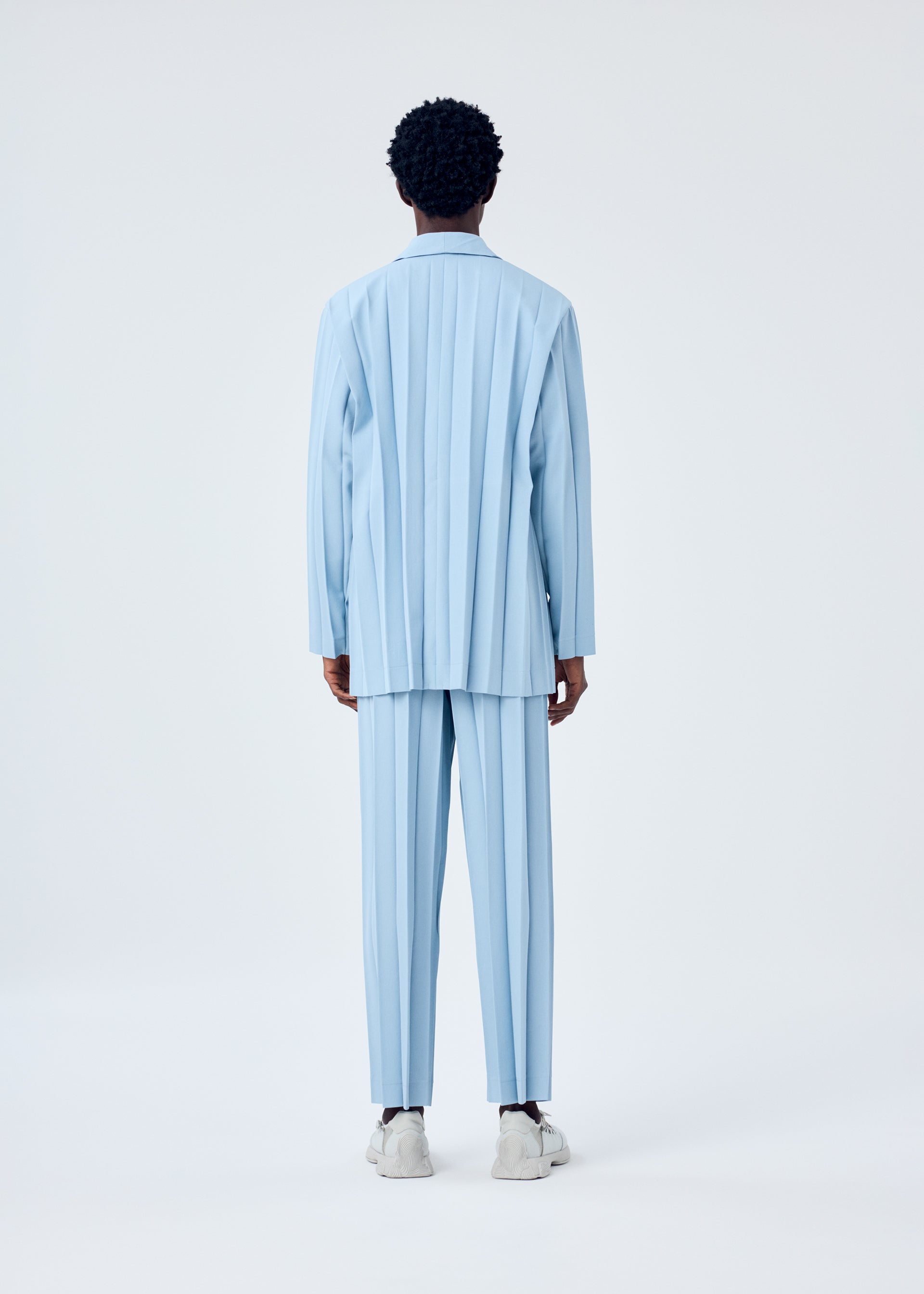 A model wears the HOMME PLISSÉ ISSEY MIYAKE EDGE ENSEMBLE jacket.
