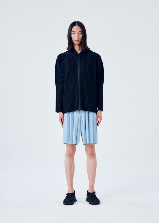 A model wears the HOMME PLISSÉ ISSEY MIYAKE EDGE ENSEMBLE trousers.