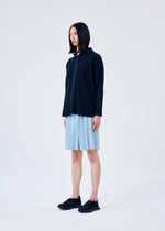 A model wears the HOMME PLISSÉ ISSEY MIYAKE EDGE ENSEMBLE trousers.