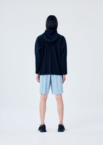 A model wears the HOMME PLISSÉ ISSEY MIYAKE EDGE ENSEMBLE trousers.