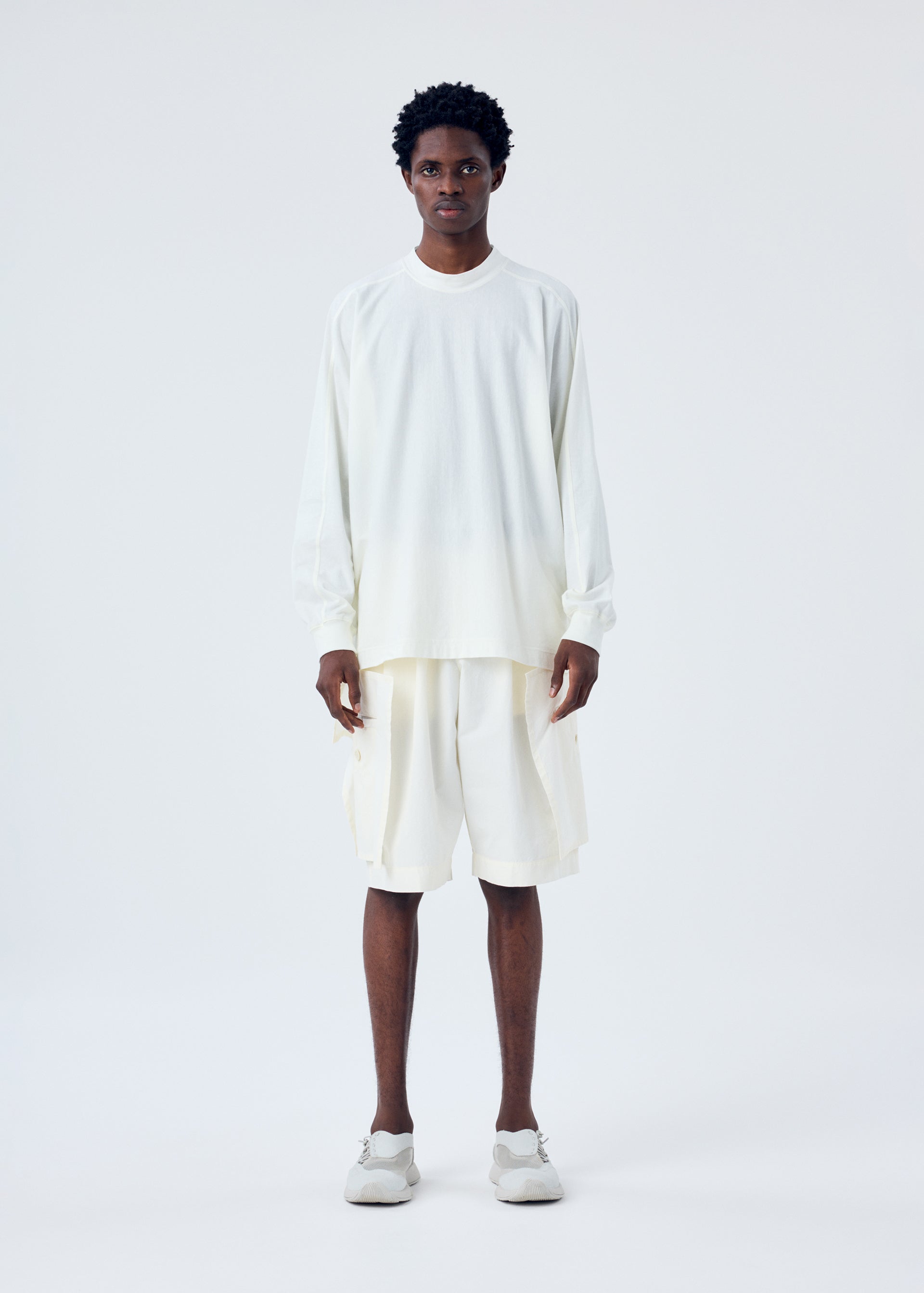 A model wears the HOMME PLISSÉ ISSEY MIYAKE FRESHEN trousers.