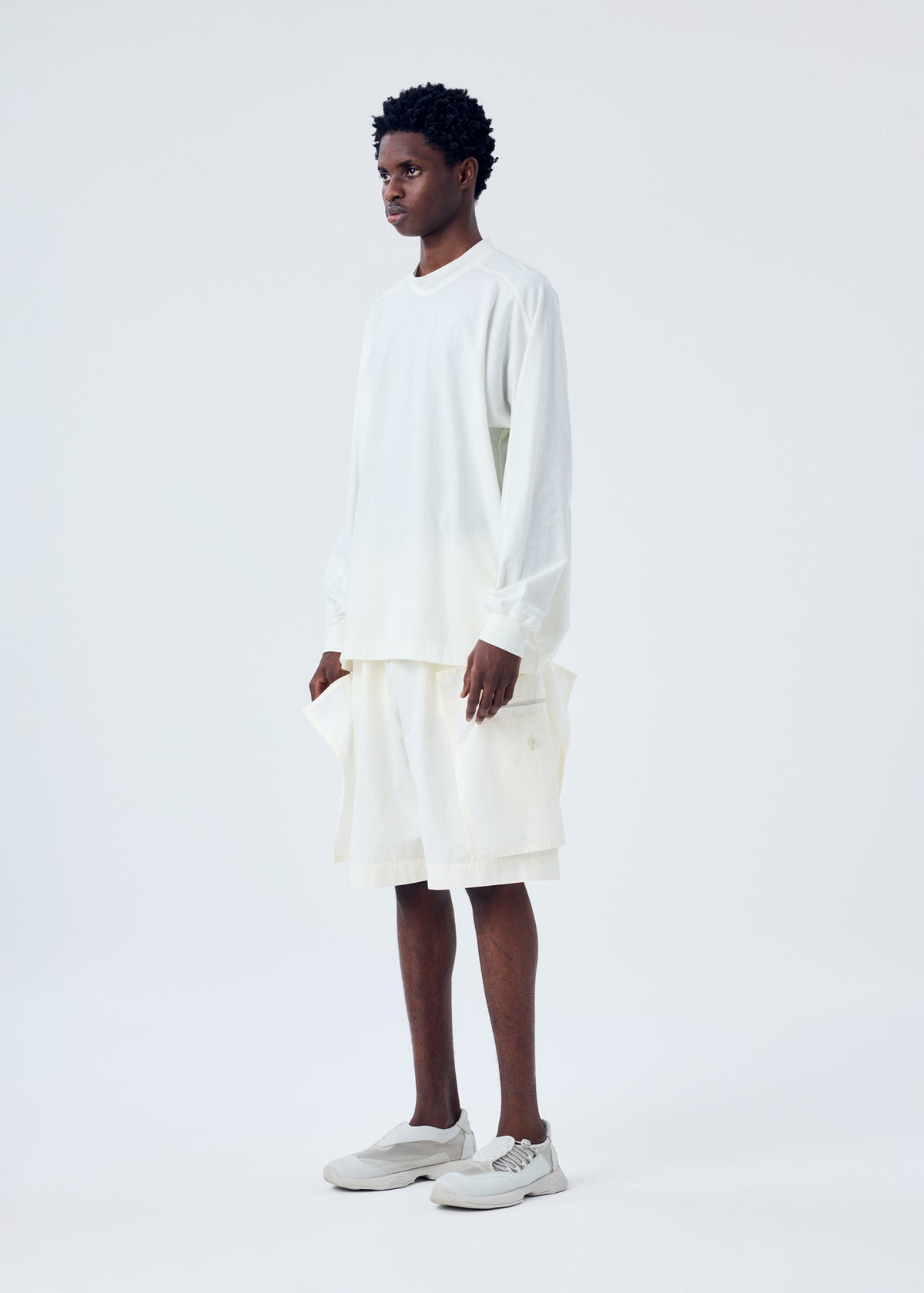 A model wears the HOMME PLISSÉ ISSEY MIYAKE FRESHEN trousers.