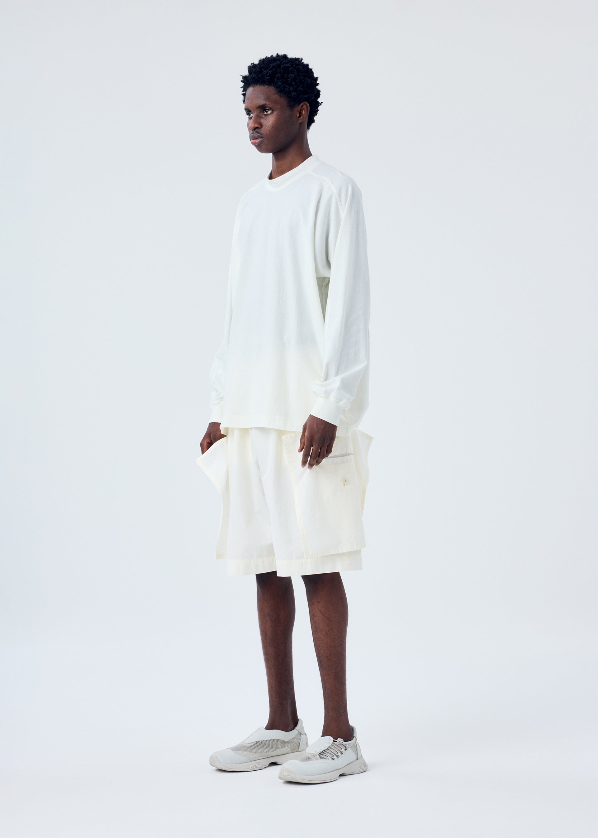 A model wears the HOMME PLISSÉ ISSEY MIYAKE FRESHEN trousers.