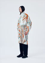 A model wears the HOMME PLISSÉ ISSEY MIYAKE WINDSWEPT PLAID coat.