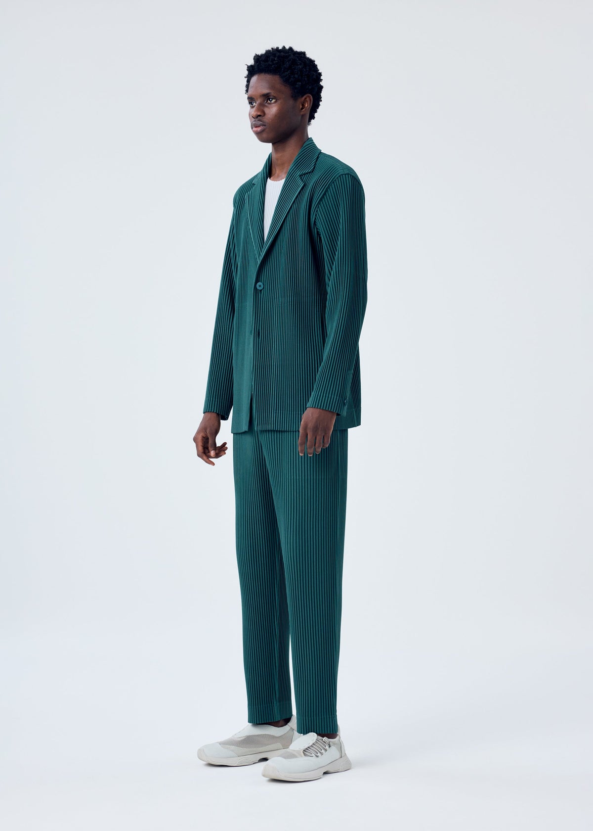 A model wears the HOMME PLISSÉ ISSEY MIYAKE TAILORED PLEATS 1 jacket.