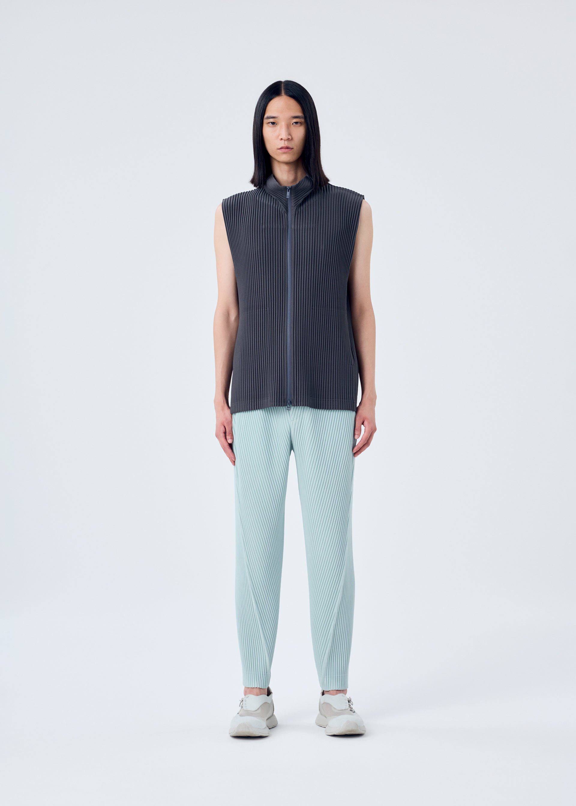 A model wears the HOMME PLISSÉ ISSEY MIYAKE MC MARCH vest.