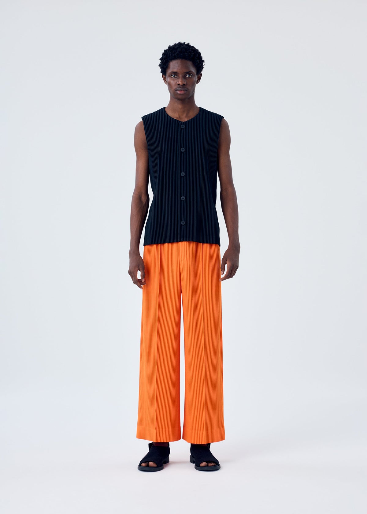 A model wears the HOMME PLISSÉ ISSEY MIYAKE TAILORED PLEATS 1 vest.