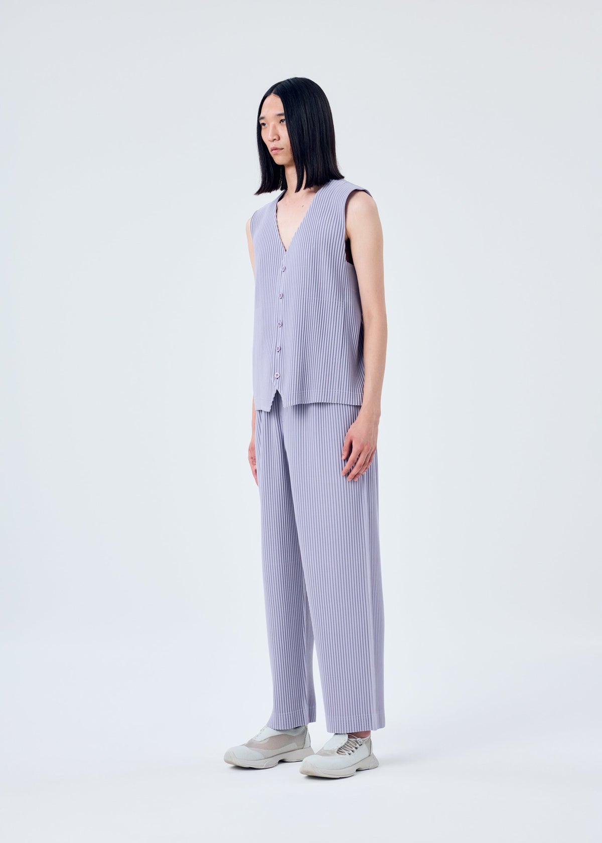 A model wears the HOMME PLISSÉ ISSEY MIYAKE TAILORED PLEATS 2 vest.