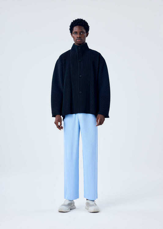 A model wears the HOMME PLISSÉ ISSEY MIYAKE MC JANUARY trousers.