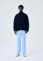 A model wears the HOMME PLISSÉ ISSEY MIYAKE MC JANUARY trousers.