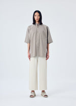 A model wears the HOMME PLISSÉ ISSEY MIYAKE MC MAY trousers.