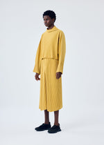 A model wears the HOMME PLISSÉ ISSEY MIYAKE MC JUNE trousers.