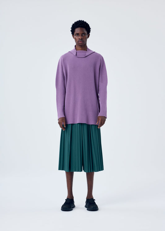 A model wears the HOMME PLISSÉ ISSEY MIYAKE TAILORED PLEATS 1 trousers.