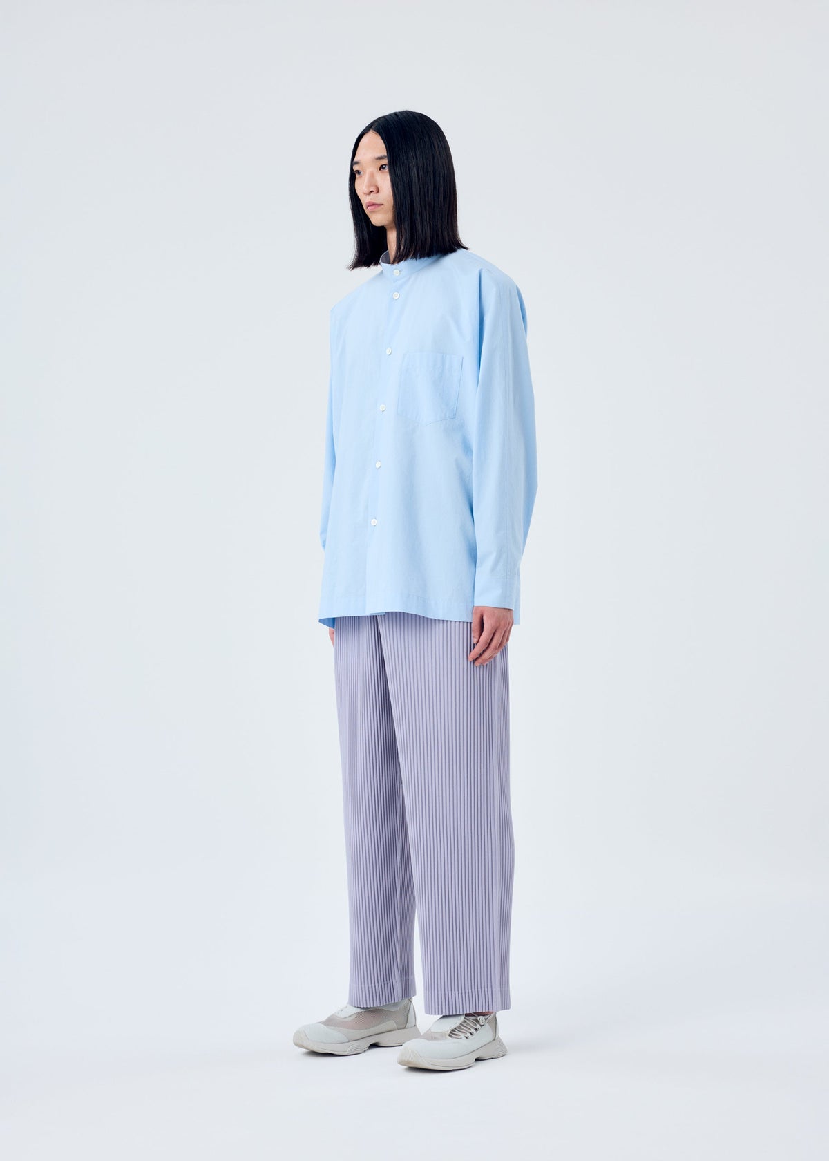 A model wears the HOMME PLISSÉ ISSEY MIYAKE TAILORED PLEATS 2 trousers.