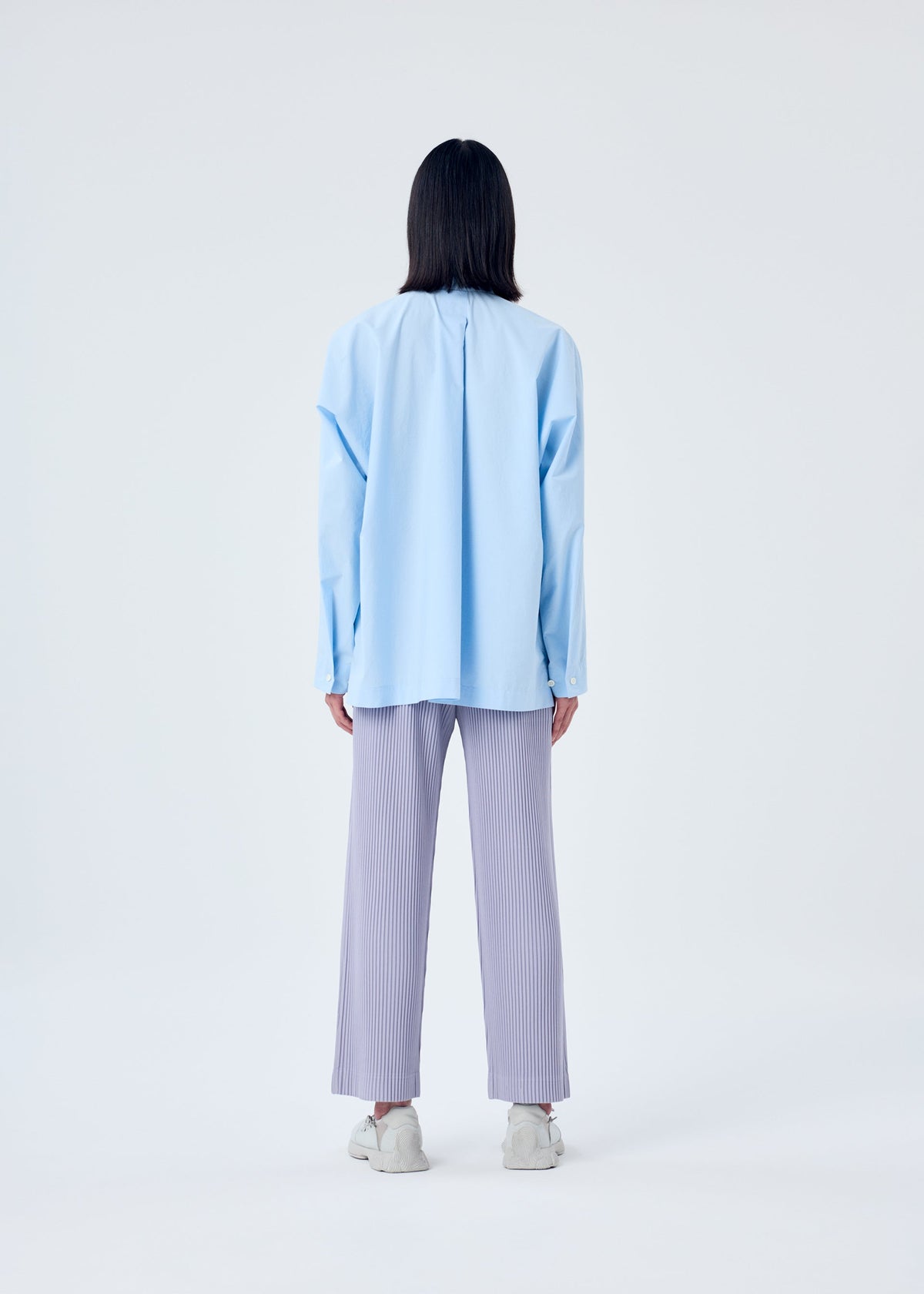 A model wears the HOMME PLISSÉ ISSEY MIYAKE TAILORED PLEATS 2 trousers.