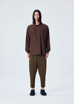 A model wears the HOMME PLISSÉ ISSEY MIYAKE HEATHER PLEATS trousers.