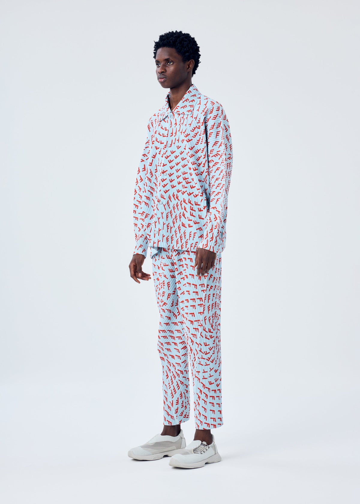 A model wears the HOMME PLISSÉ ISSEY MIYAKE WIND SPEED trousers.
