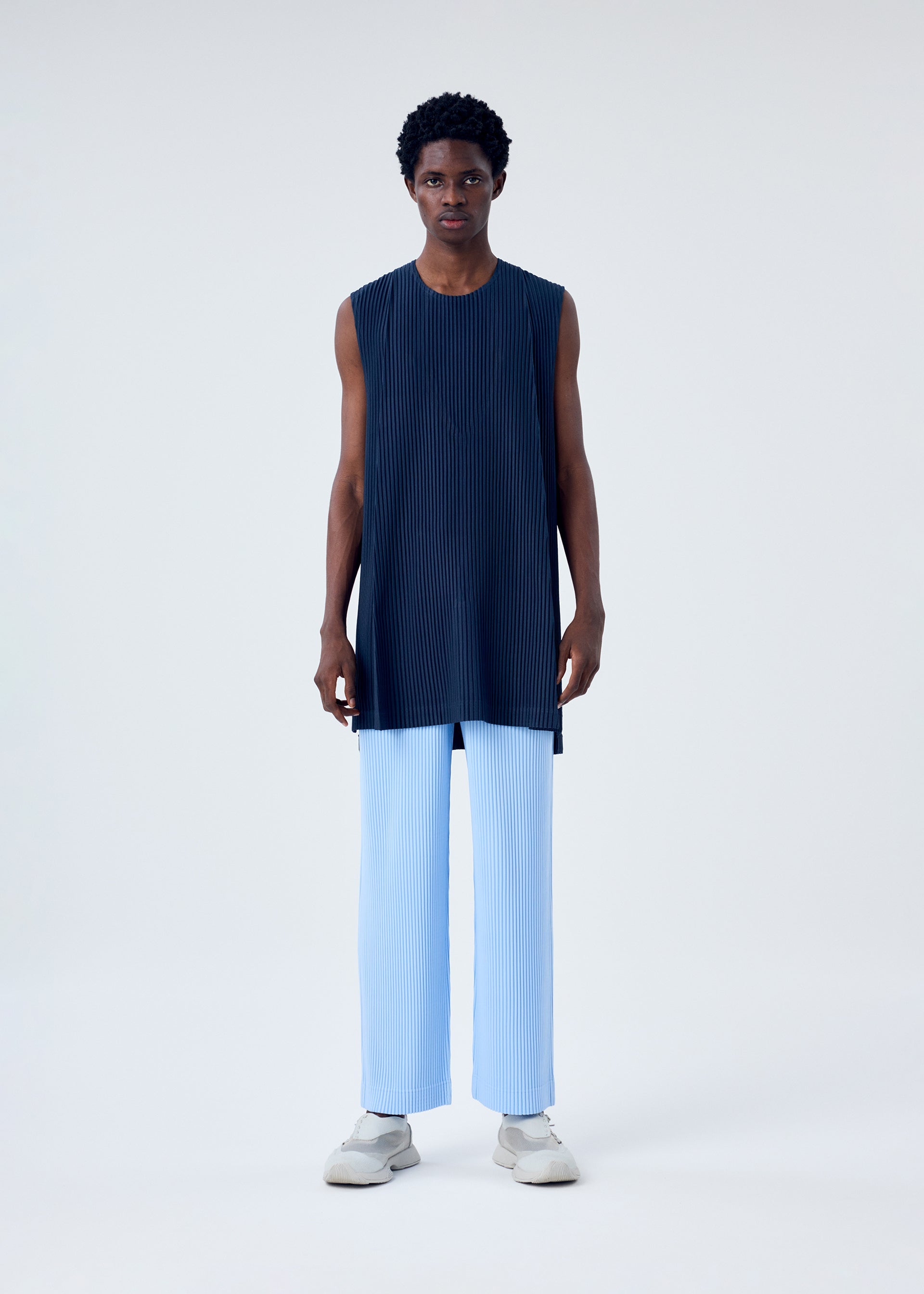 A model wears the HOMME PLISSÉ ISSEY MIYAKE MC JANUARY top.