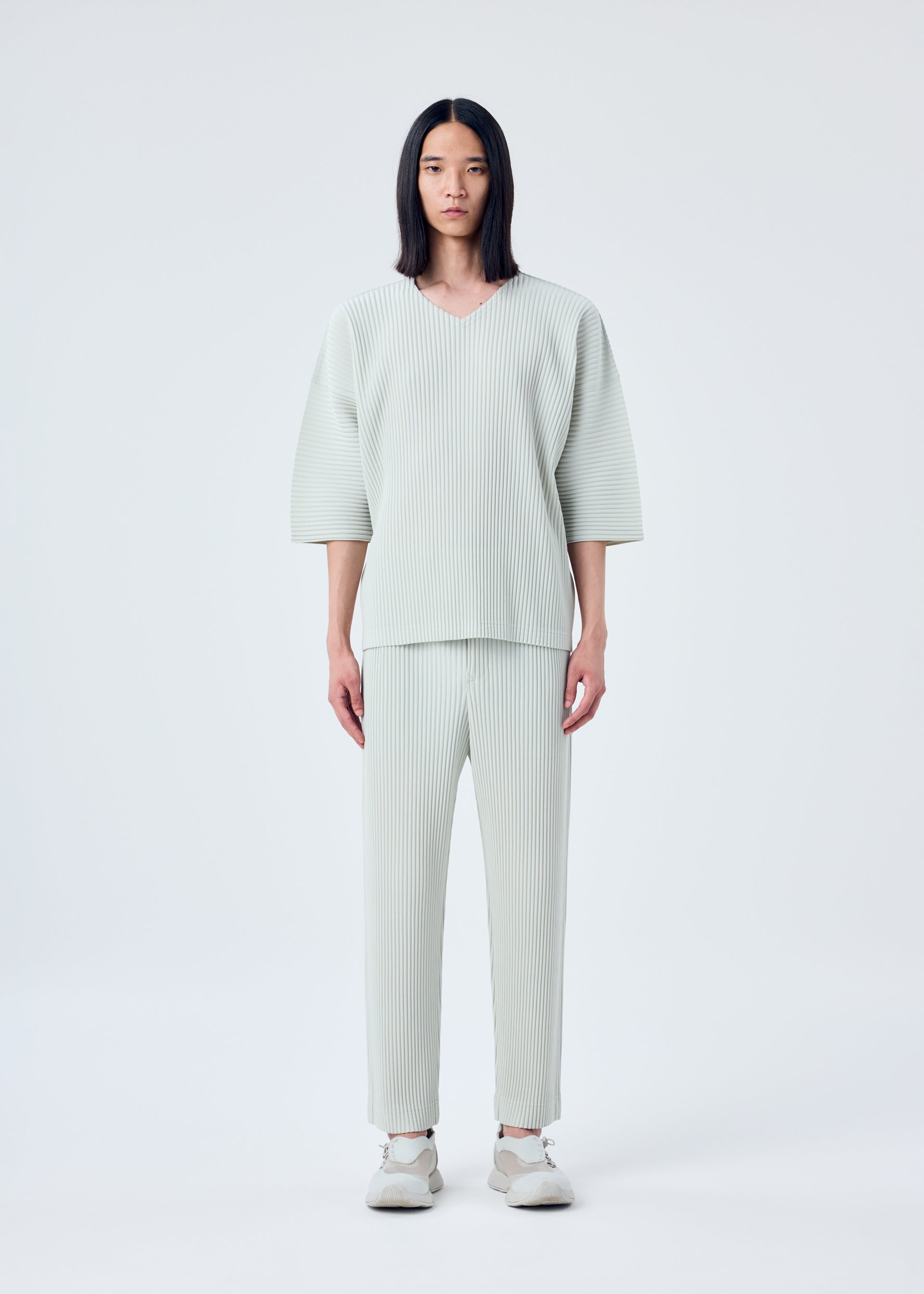 A model wears the HOMME PLISSÉ ISSEY MIYAKE MC MARCH top.