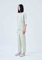 A model wears the HOMME PLISSÉ ISSEY MIYAKE MC MARCH top.