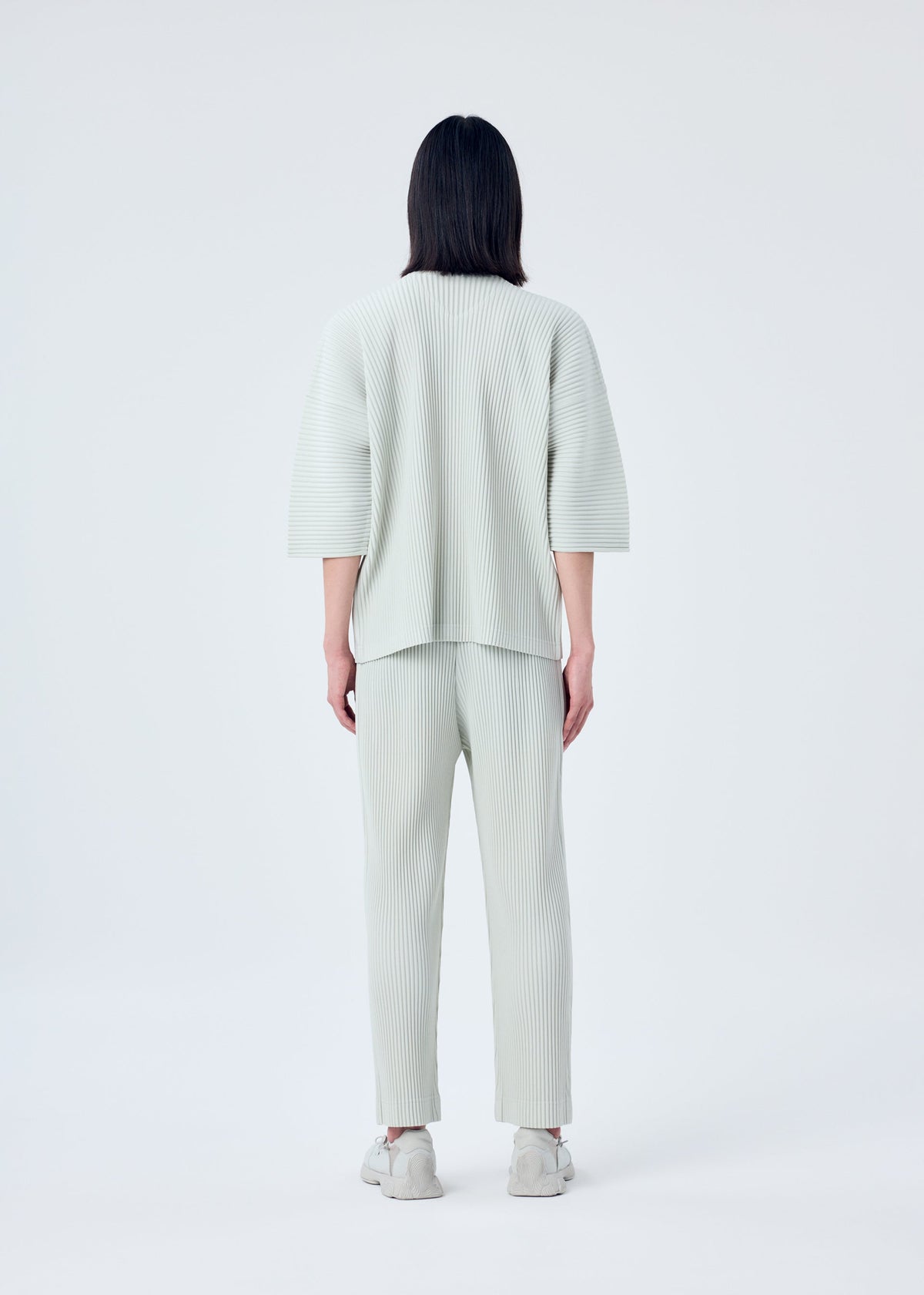 A model wears the HOMME PLISSÉ ISSEY MIYAKE MC MARCH top.