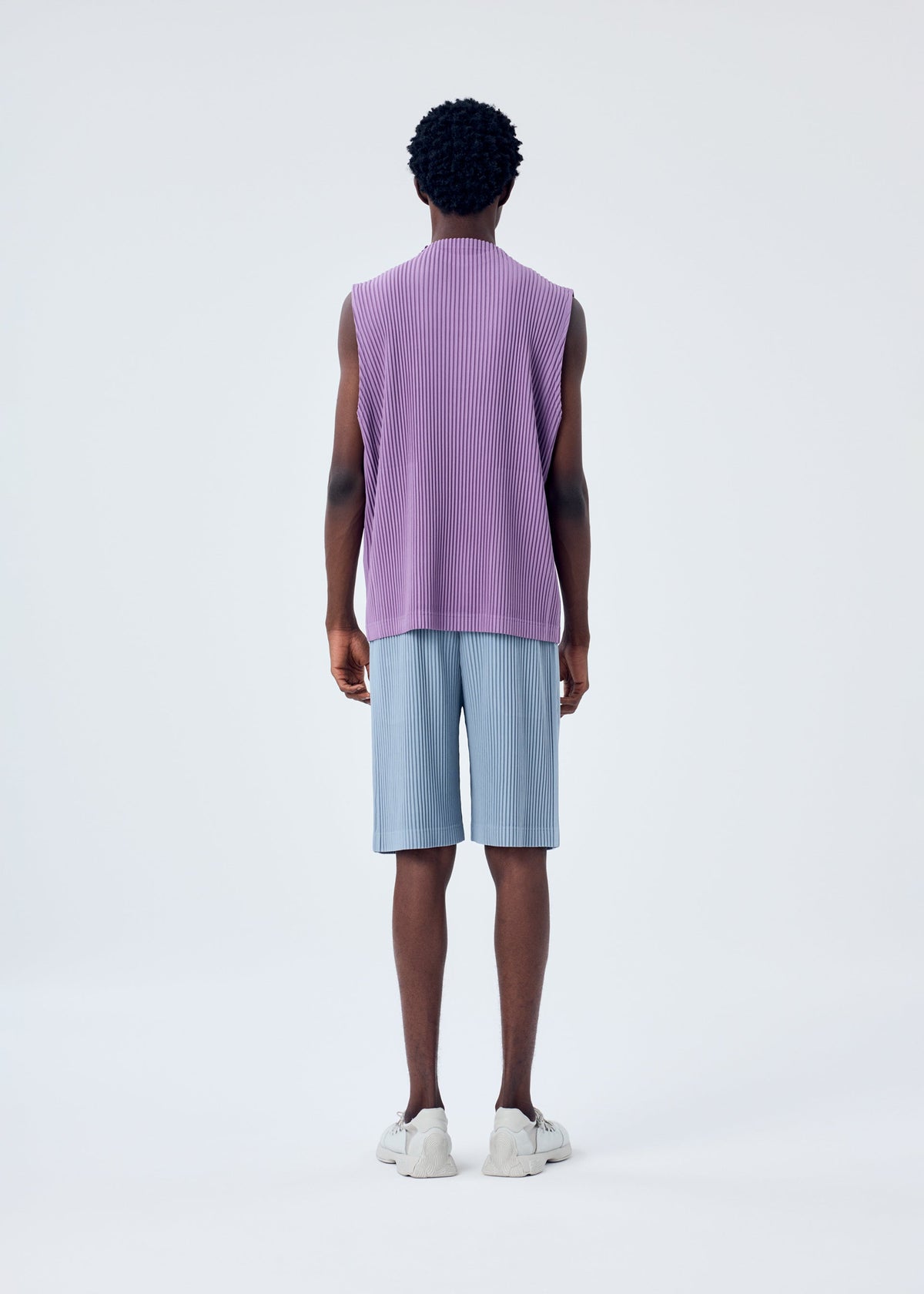 A model wears the HOMME PLISSÉ ISSEY MIYAKE MC APRIL top.